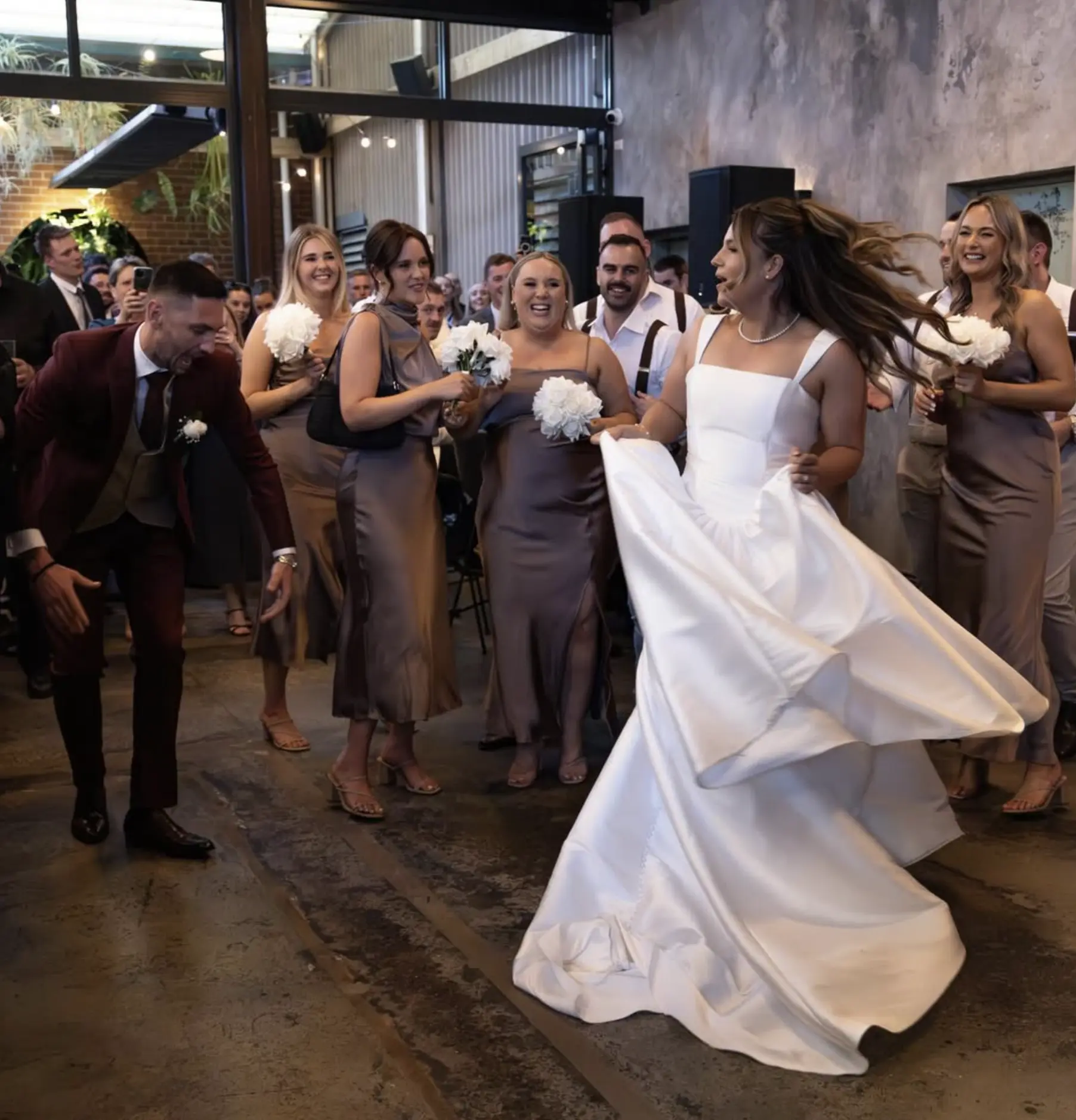 Bride dancing with family and friends at a celebration